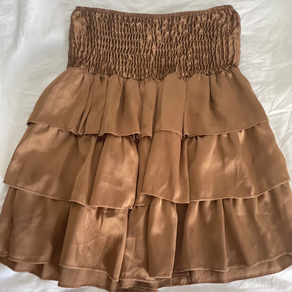 Jättefin brun glansig volang kjol, köpt i Italien så de står inte storlek men skulle säga att den passar i princip alla då den är väldigt stretchig!!nästan aldrig använd. Kjolar.