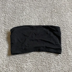 Bandeautopp - Svart bandeautopp Gubbi/silikon som gör att den inte glider ner