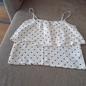 Tops - This is a very cute top that have small black heart on it. 