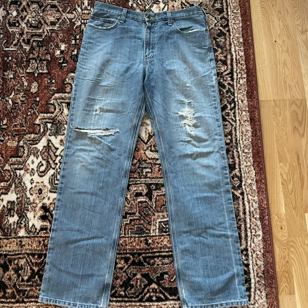 Säljer dessa svin snygga carhartt jeans med distressing i relaxed fit. Köpt vintage och i gott skick!. Jeans & Byxor.