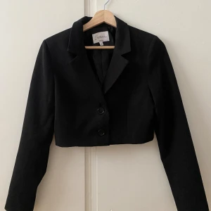 Croppad kavaj - Svart croppad kavaj från nakd x Emma ellingsen. Använd några gånger men varan är i gott skick 🩵