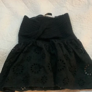 Svart Zara topp Xs💕 - Säljer Zara topp med knut i mitten. Toppen har fint mönster nertill! Nypris 200 kr och säljer för 95kr. Endast använd 4 gånger!💗 Toppen är i Xs