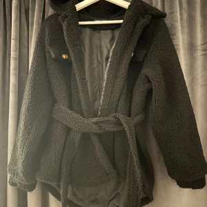 Svart teddykappa - Svart teddykappa med bälte runt midjan