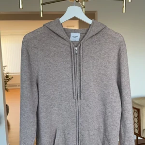 Kashmir Hoodie-John Henric - Säljer Kasmhir Hoodie färgen beige, som är nästan helt ny. Bara använts ca 3 gånger. Ny pris är 2500. Inga skador alls. Storlek M.