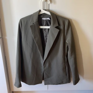 Olivgrön kavaj från nakd - Kavajen är i bra skick. Den är i strl 34.