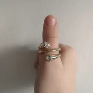Storlek: M, L. Jag säljer denna fina ring pga att den inte är min stil. Har köpt på H&M. Fake guld och Fake diamanter!!! Köpte för 70kr.