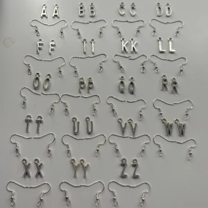 Bokstäver berlocker som örhängen  - Dessa är örhängen som jag gör själv. Ni bestämmer själva vilken färger ni vill ha. Men det finns bara de färger som är med på bilderna. Dessa är aldrig använda. Skriv till mig om du undrar något. OBS! När du köper denna kommer du endast köpa ett par!