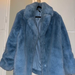 Blå pälsjacka (fejk päls) stor och mysig - I bra skick. Knappt använd, jättevarm och mysig. Tidlös. 