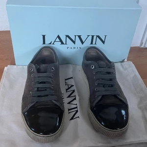 Mörkblå Lanvins skor - Säljer mina gråblå lanvinskor. Skorna är väl använda men har mycket kvar att ge. Det finns en liten repa på lacken och sulorna är ganska slitna. Annars bra skick. Färg:grönbrun. Storlek 40 men funkar för 40-42 skulle jag säga. Skriv för mer bilder. 