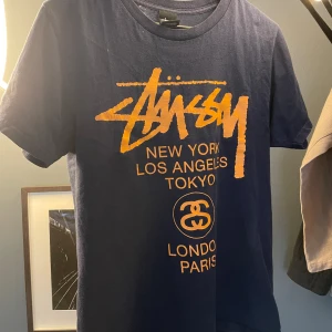 Stüssy T-shirt - Stussy on tour t-shirt som tyvärr är för liten för mig. Printet är dock lite krackylerat.