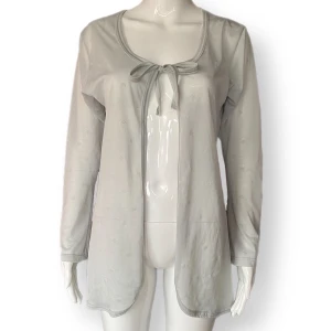 Blommig Kofta  - Genomskinlig kofta med blommor. Ljusblå färg! Från Wear It, storlek M. 100% polyester. 