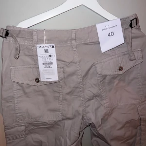 Cargo byxor, justerbara med spännen i bak - Aldrig använda säljer pga för små