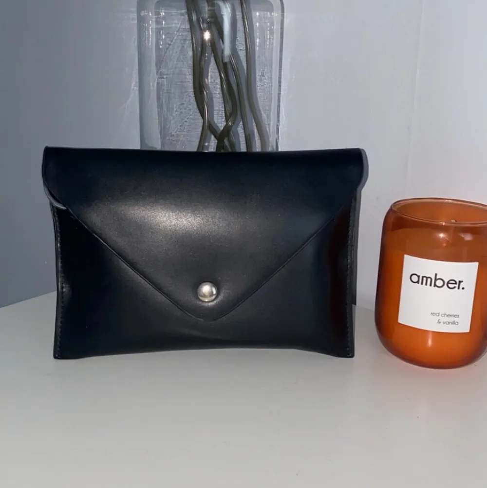 En liten svart kuvertväska för både utgång och vardagar som får plats med de mest nödvändigaste, väldig stilig detalj till era outfits<3. Väskor.