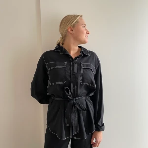 Fin längre skjorta - Bra skick, vita sömmar som detalj, tillhörande skärp!