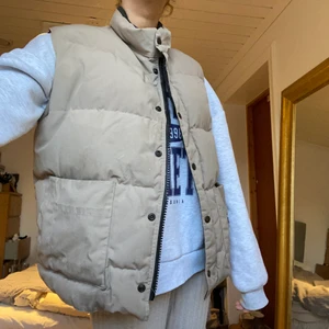 Canada Goose väst - Beige Canada Goose väst! Står tyvärr inte storleken någonstans men skulle uppskatta den till M. Några fläckar längst ner på framsidan (se på sista bilden) , därav nersatt pris! Men skulle säga att man knappt märker det när man bär den!