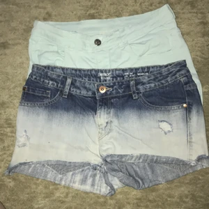 Barnkläder  - Två blåa shorts och en klänning. Ps: Det shortset som ser ut att vara vit är ljus turkos och klänningen är lite nopprig. Alla i använt skick.