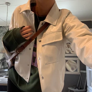 Vår/sommar Jacka - Världens finaste vår/sommar jacka som är perfekt för sommarkvällar och kyliga sommardagar! Jackan kommer från Nelly och är slutsåld på hemsidan, jackan är i lite ”regntåligt” material och är vit glansig! Hör av er om ni vill ha flera bilder! Inköpt för 499kr. Inga defekter eller liknande nästan som ny! ❤️🌸