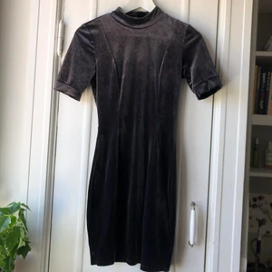 Mörk blå sammetsklänning  - Kort tajt sammetsklänning med kort polokrage från Ginatricot. Använd en gång, säljs pga för liten.  •Storlek: XS  Färg: Grå/blå