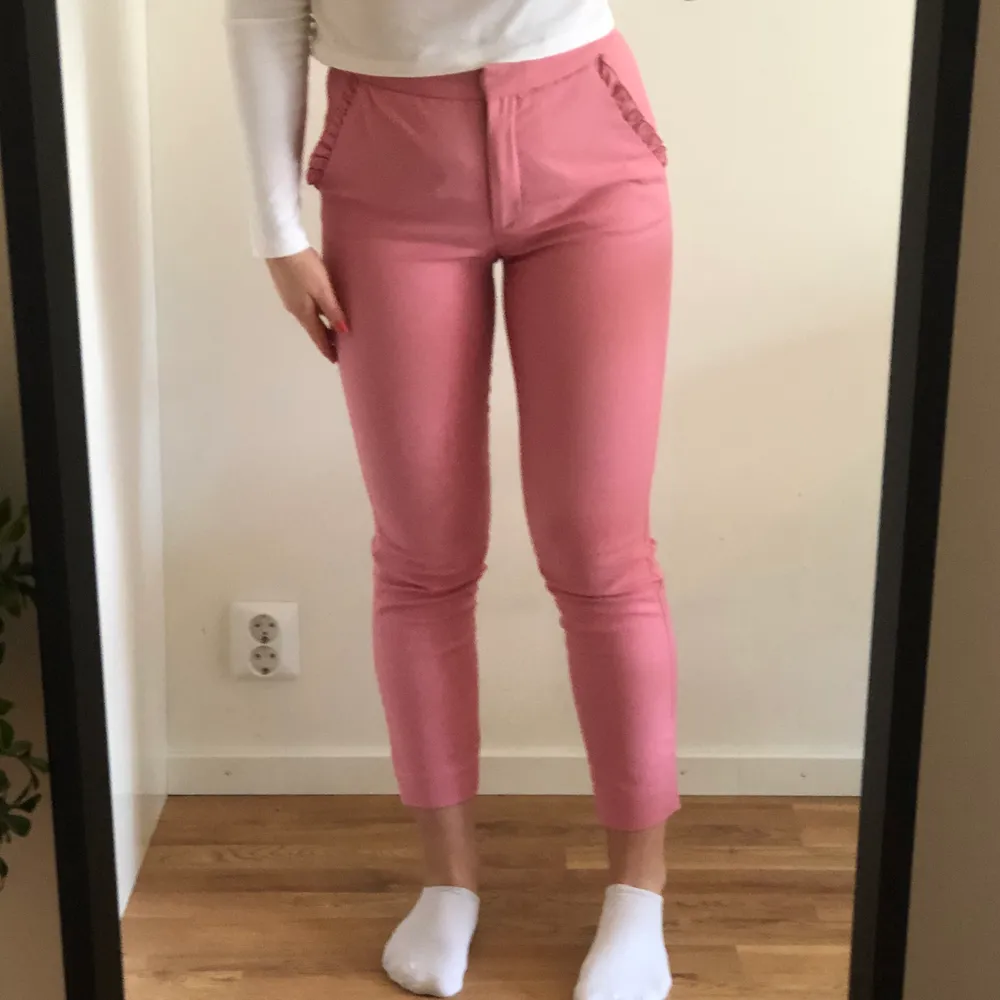Söta rosa kostymbyxor i strl. s från Zara med volanger på fickorna. I använt men fint skick.. Jeans & Byxor.