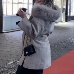 Kappa med äkta päls  - Kappa i ull/Kashmir med avtagbar rävpäls på luvan.  Använd 1 gång och köpt för 2199kr snöre i midjan. Storlek S/M priset går att diskuteras vid snabb affär. ( Inte mina bilder) fler bilder kan fås vid intresse  