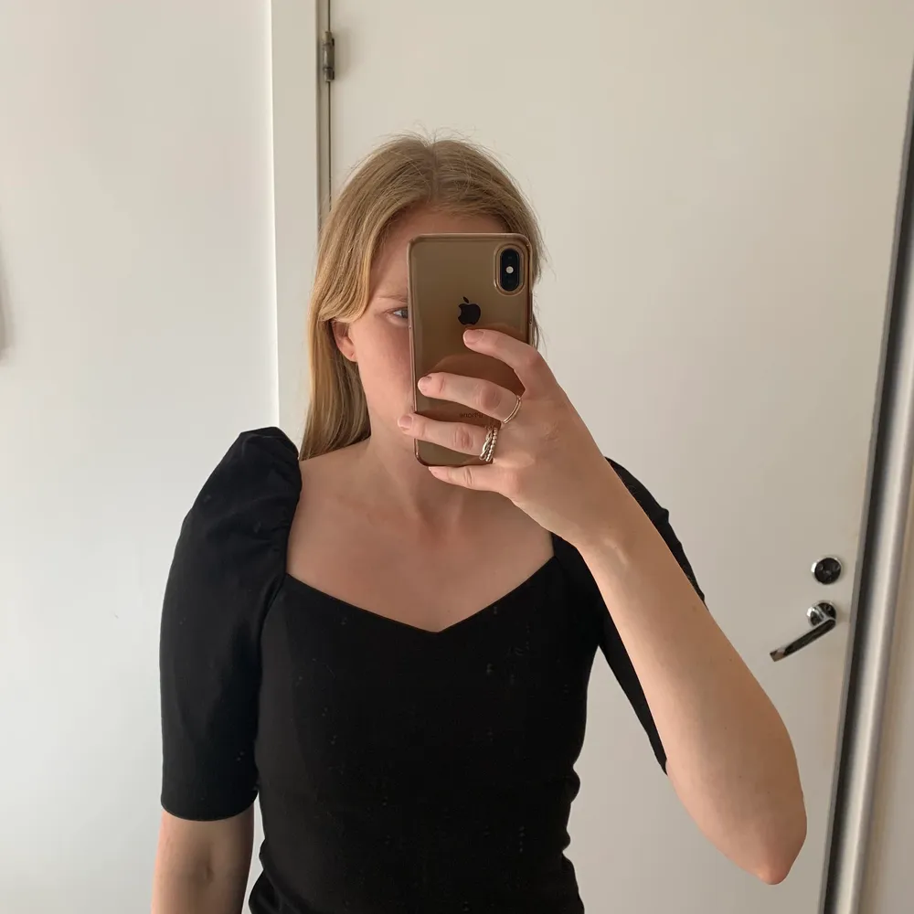 Fin svart tröja med puffärm från H&M. Helt oanvänd. Superfin hjärtformad rigning och den är perfekt till kjol och byxor. . Toppar.