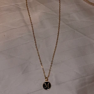 Halsband med M initial  - Ett halsband jag haft i närmare 3 månader, aldrig använt unt eggar tillfälle för det. Halsbandet är i färgen guld och är justerbar.