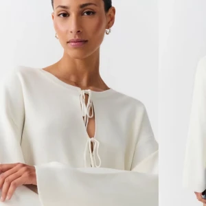 Kräm Vit  kofta med snörning från Ginatricot  - Superfin krämvit kofta från Ginatricot med vida ärmar och snygg snörning framtill. Aldrig använts 