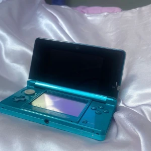 Nintendo 3DS + Nintendogs Golden Retriever & New Friends+laddare - Säljer en fullt fungerande Nintendo 3DS i färgen Aqua Blue i mycket fint skick samt tillbehör. Fungerar felfritt.   Detta ingår:  • Nintendo 3DS-konsol  • Original stylus (touchpenna)  • Original laddare (modell WAP-002)  • Spelet Nintendogs + Cats: Golden Retriever & New Friends 
