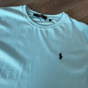Polo Ralph Lauren T-shirt  - Tjena, säljer denna stilrena riktigt fina polo T-shirten i slim modell. Perfekt nu inför sommaren. På tröjan står det S, dock är den lite lång och skulle passa M också. Skriv gärna vid intresse och för mer information. Skriv gärna vid intresse! 
