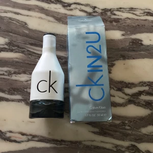 CK IN2U Him Eau de Toilette - Fräsch och modern herrparfym från Calvin Klein, CK IN2U Him. Flaskan är vit med svart botten och har en stilren design. Kommer i originalförpackning med metallicblå text. Volym: 50 ml men har använt fåtal gånger.