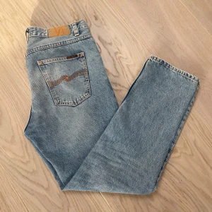 Ljusblå jeans från Nudie Jeans - Snygga blá jeans frán Nudie, köpte de nagra veckor sen men inte fätt nägon användning alls sả skicket är som nytt. Passformen är relaxed och passar lite längre i längden. Priset är inte hugget i sten sa bud ar valkommmna.