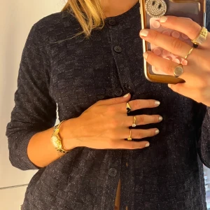 Mörkblå kofta med gulddetaljer - Snygg mörkblå cardigan jacka från Bondelid i storlek S. Jackan har ett diskret rutigt mönster, knappar framtill och är långärmad. Perfekt för dig som gillar klassisk stil med en twist. Passar till jeans eller kjol för en chill look.