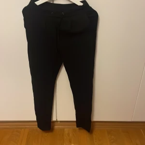 Svarta mjukisbyxor från Vila XS - Svarta mjukisbyxor från Vila i storlek XS. Byxorna har dragsko i midjan och smal passform med avsmalnande ben. Perfekta för en chill och avslappnad look. Mjukt material och klassisk design.