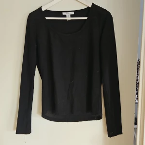 Svart långärmad topp - Säljer en stilren svart långärmad topp. Perfekt basplagg med rund halsringning och mjukt material. Passar till många olika outfits och tillfällen.