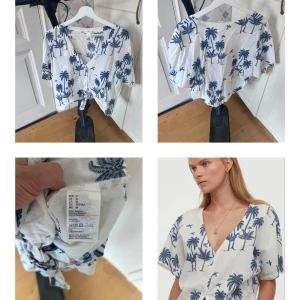 Vit blus med palmmönster från Desmond & Dempsey x H&M - Säljer en vit blus med blått palmmönster från Desmond & Dempsey x H&M. Blusen har korta ärmar och en knytning framtill. Perfekt för en somrig look!