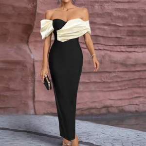 Svart långklänning med offshoulder - Supersnygg svart långklänning med offshoulder och ljus cremefärgad omlott-detalj över bysten. Klänningen har figurnära passform och axelbandslös design som ger en elegant siluett. Perfekt för att sticka ut på bal eller fest.