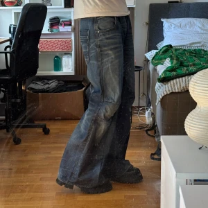 Dark Blue Baggy Flared Denim Jeans - Oken.studios handmade baggy flared denim jeans with a unique dark blue wash! Lays nicely over boots/shoes! Size 33/34 Waist: 43cm Length: 109cm Leg opening: 34cm  Model is 184cm tall