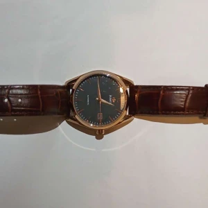 Brun klocka med guldtonad boett - Elegant klocka från Romon med en brun urtavla och guldtonad boett. Klockan har ett brunt läderarmband med krokodilpräglat mönster och en datumvisning vid klockan 3. Perfekt för den stilmedvetne! Äkta vara finns ej kvitto fick den av en polare