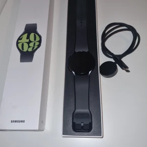 Samsung smartklocka - Säljer en stilren Samsung smartklocka i svart med rund urtavla. Klockan kommer med originalförpackning och laddkabel. Perfekt för den teknikintresserade som vill ha koll på både tid och hälsa. Klockan är helt nu har knappt använt den för att jag känner att den inte passar till mig. 44mm