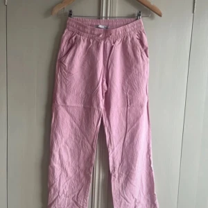 Rosa linnebyxor  - Säljer mina rosa linnebyxor som är köpa från lager 157 i strl 150. 💕 Säljer då jag tyvärr nu växt ur dem!  Men dessa byxor är lite mindre i storleken så som en 140! 🌺 Så fina och mycket fint skick, de vill säga hela och rena! 🌟  Resår och dragsko i midjan, två sidfickor och en bakficka.  Rökfritt hem och ej något djur.