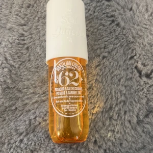 Sol de Janeiro Brazilian Crush 62 - Fräsch och söt body mist från Sol de Janeiro, Brazilian Crush Cheirosa 62. Doft av pistage och saltad karamell. Flaskan är genomskinlig med orange ton och har en vit spraykork. Perfekt för både kropp och hår. Jag har endast sprejat nåt sprut men inte alls mycket,(se på bilden)