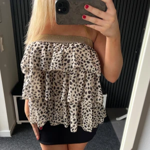 Beige volangig tubtopp med leopardmönster - Köp via instabox!! Säljer en leopardmönstrad kjol med flera volanger som går att använda både som kjol eller topp. Kjolen har en glittrig, bred resår upptill som håller den på plats. Står ingen storlek men skulle uppskatta den som en S men den är även väldigt stretchig så passar även större storlekar