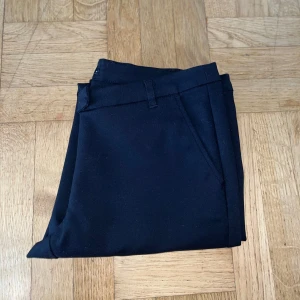 Svarta kostymbyxor  - Stilrena svarta kostymbyxor från Vila med diskreta fickor fram och bak samt hällor för bälte. Byxorna har storleken 40 men passar som 38! 🖤