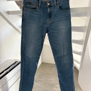 Blå jeans från Polo Ralph Lauren - Snygga blå jeans från Polo Ralph Lauren med klassisk femficksdesign och raka ben. Jeansen har normal passform och är i bra skick. 