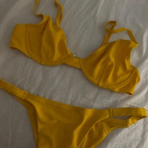 Gul bikini - Säljer en snygg gul bikini från Nelly. Använd några få gånger men i bra skick. Storlek M & 75C. 50kr + frakt😊