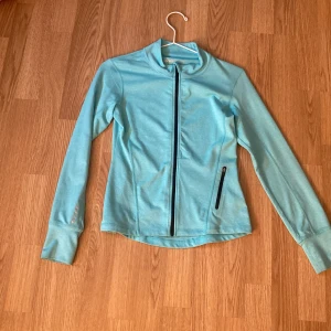 Ljusblå träningsjacka från SOC - Säljer en ljusblå träningsjacka från SOC i storlek 146/152. Jackan har lång ärm, dragkedja framtill och en ficka med dragkedja på sidan. Perfekt för träning eller utomhusaktiviteter. Snygg och sportig design! Knappt använd ☺️