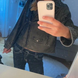 Svart/grå jacka med nitar från Zara - Cool svart/grå jacka från Zara med silvriga nitar på krage och ärmslut. Aldrig använd❣️Jackan har dragkedja framtill, två fickor med dragkedja och en liten ficka med knapp. Snygg bikerstil som ger en edgy vibe till din outfit.💖