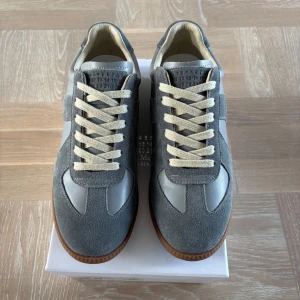 Maison margiela gats grå - Nya Maison margiela gats gråa med vit snöre, säljer pga för små, hör av dig vid frågor eller pris förslag. Super bra kvalité obs inte Orglnal