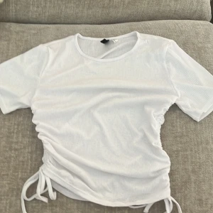 Vit ribbad topp med snörning H&M Divided - Säljer denna vita topp med snören från hm divided i storlek S💕