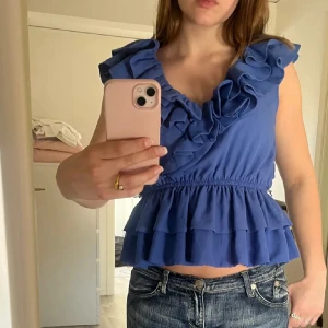 Populär H&M volangtopp  - Säljer min populära H&M volangtopp som är väldigt eftertraktad i storlek 40 men sitter som en XS/S. Själv bär jag alltid XS eller S och den passar mig bra. 🩵💙 Behöver pengar därför säljer jag men älskar den jätte mycket 